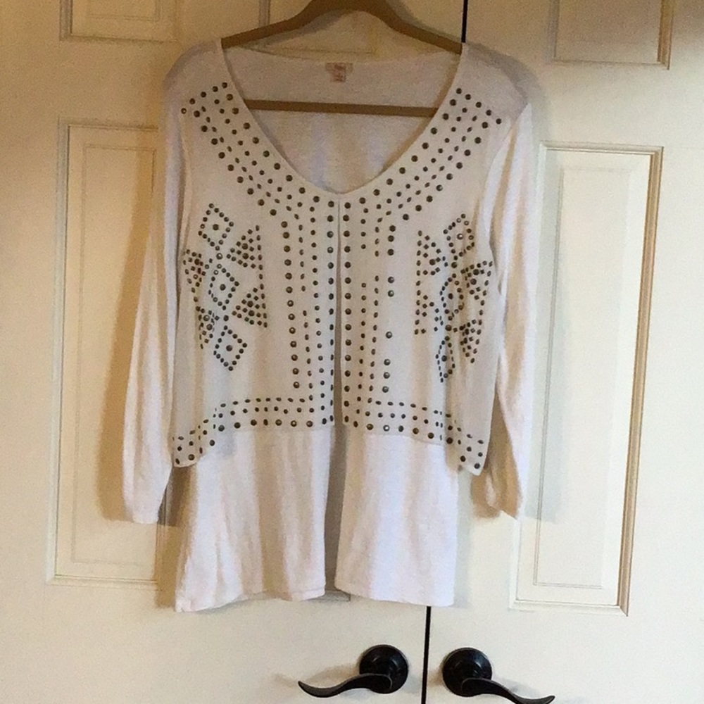 Reba cream pullover top with overlay and brass decorative accents.